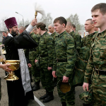 Russian constrcipts are blessed by a proest